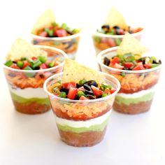 small cups filled with different types of food