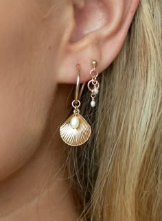 ALANA MARIA JEWELLERY - This enchanting piece will become a favourite in your collection. Captivating upon first glance these earrings feature a charming shell pendant accompanied by a Freshwater Pearl details and delicately hung from a 14k gold-filled Hoop. Adorn yourself with the beautiful Ula Shell Hoop earrings, pair alone or in a stack to achieve a beautifully curated ear. - Sold as a pair- Hoop earring- Shell pendant feature-Freshwater Pearl detail- 14k gold-filled Hoop measurement: 15mm Please note, due to hygienic purposes we do not refund or exchange any Alana Maria Jewellery earrings Alana Maria Earrings, Dainty Shell-shaped Pearl Charm Jewelry, Elegant 14k Gold-filled Hoop Earrings With Dangling Charms, Elegant 14k Gold Filled Hoop Earrings With Dangling Charms, Elegant Gold Plated Shell Jewelry, Shell-shaped Single Earring For Gift, Elegant Gold Shell Hoop Earrings, Elegant Shell-shaped Gold Hoop Earrings, Dainty Shell-shaped Jewelry