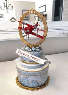 a christmas ornament on top of a cake with a ribbon around the base