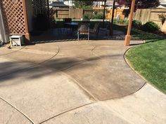 an outdoor patio with table and chairs in the back yard, next to a pergolan