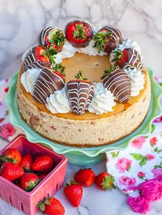 there is a cake with strawberries on the top and other desserts around it