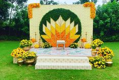 an outdoor ceremony setup with flowers on the table and chairs in front of it, surrounded by greenery