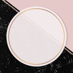 a round white plate on a black and pink background