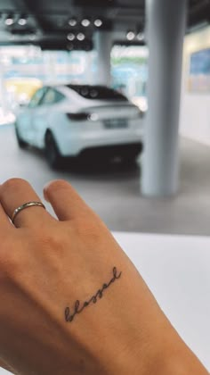 a person's hand with a small tattoo on their left wrist and the word love written in cursive writing