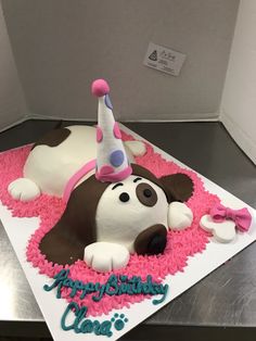 a birthday cake that looks like a dog laying down