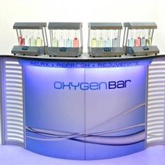 an image of a reception counter with four lights on it's sides and the words oxygen bar written in blue