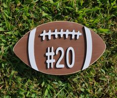 a wooden sign with the number twenty two on it sitting in some green grass,