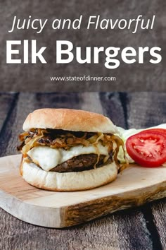 a cheeseburger on a wooden cutting board with tomatoes