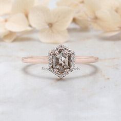 an engagement ring with a brown diamond surrounded by white flowers