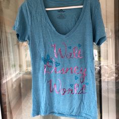 This Is A Super Cute Light Blue T-Shirt From Walt Disney World. Features Some Metallic Text On The Front Saying Walt Disney World. Brand New With Tag. Size Large But Runs Very Small, More Like A Juniors Large Or Women’s Small. V-Neck Cut. Casual Tops For Disney Trips, Blue Disney T-shirt For Disney Trips, Disney Blue Cotton Tops, Blue Graphic T-shirt For Disney Trips, Blue Graphic Tee For Disney Fan Events, Blue Disney Cotton Tops, Blue Disney Tops For Disney Trips, Blue Disney Style Tops For Disney Trips, Letter Print Short Sleeve Tops For Disney Trips