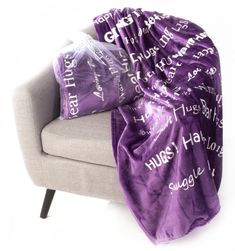 a couch with a purple blanket on top of it