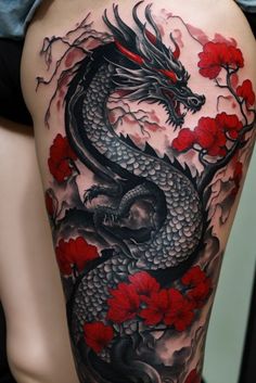 a woman's thigh with a dragon and flowers on it