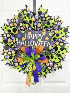 a happy halloween wreath hanging on the front door