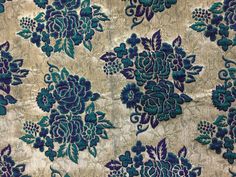 a blue and green floral pattern on fabric