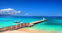 a boat is docked at the end of a pier