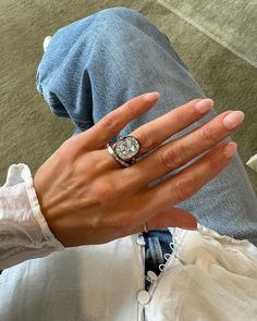 a person wearing a ring with a diamond on it