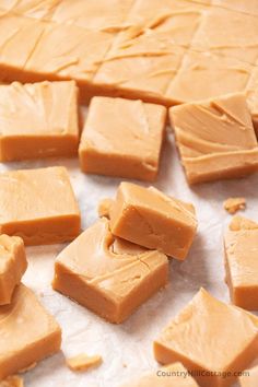 several pieces of caramel fudge sitting on wax paper