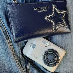 a camera sitting next to a blue purse