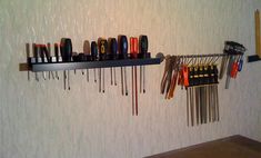 there are many different tools hanging on the wall