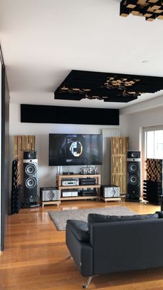 a living room filled with furniture and speakers