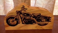 a wooden block with a drawing of a motorcycle on it