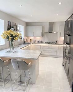 a kitchen with two stools and a center island