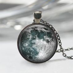 Handmade art pendant necklace featuring a magnificent blue and white full moon. You can choose your finish between antique silver, gunmetal, antique bronze or antique copper.**********************************************************************This beautiful pendant is handcrafted by me... using a high quality art print image and is protected by a beautiful crystal clear domed glass cabochon which enhances the image for a truly stunning effect!The glass cabochon measures approximately 1 inch in Handmade Moon-shaped Artistic Jewelry, Handmade Artistic Moon-shaped Jewelry, Handmade Moon Shaped Artistic Jewelry, Antique Moon Phase Jewelry Gift, Antique Round Necklace With Moon Charm, Antique Moon Shaped Jewelry For Gift, Antique Moon Shaped Jewelry Gift, Antique Moon-shaped Jewelry Gift, Moon Print Moon Shaped Necklace For Gift