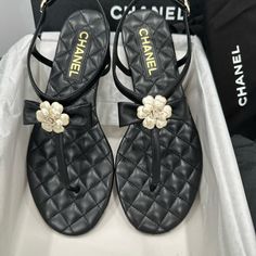 Chanel 2023 Black Quilted Leather Thong Sandals With Bow Camellia Cc Logo. Size 39= 8.5 Us Brand New In Box With Dust Bag. Luxury Sandals With Single Toe Strap For Spring, Luxury T-strap Sandals For Evening In Spring, Luxury Evening T-strap Sandals For Spring, Luxury Summer T-strap Toe Post Sandals, Designer Toe Post Sandals For Spring, Designer Toe Post Sandals, Luxury Toe Post T-strap Sandals For Summer, Luxury Black Leather Flip Flops, Luxury T-strap Sandals With Open Heel For Spring