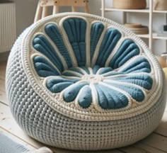 a blue and white chair sitting on top of a wooden floor