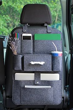 the back seat of a car with two pockets for books and other items in it