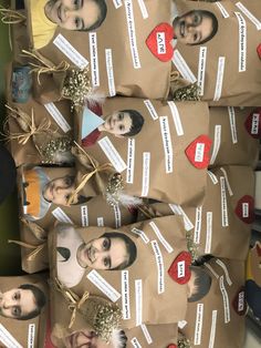 some brown paper bags with pictures of people on them and tags attached to each bag