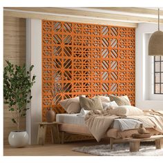 a bed sitting in front of a window next to a wooden wall mounted headboard