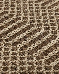 a brown and white rug with lines on it