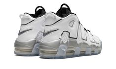 The Women’s Nike Air More Uptempo “White Metallic” is a women’s version of the retro basketball shoe with a flashy appearance.  In the “White Metallic,” Nike updates the Air More Uptempo, the shoe worn by Scottie Pippen with the Chicago Bulls during the 1995-96 NBA season, with a versatile look.  The shoe features a white leather construction with its signature graffiti-inspired “AIR” branding on the sides outlined in metallic silver.  The black mesh tongue, laces and elastic overlay straps add Nike Air More Uptempo, Nike Air More, Retro Basketball Shoes, Scottie Pippen, Retro Basketball, Metallic Shoes, Nba Season, Stadium Goods, Silver Accents