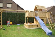 a child's play area with swing set, slide and climbing frame in the back yard