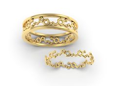 two gold rings with hexagonal designs on them