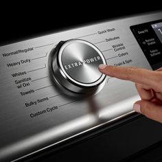 a person pressing the button on an appliance that has extra power written on it