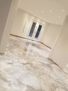 an empty room with white walls and marble floors