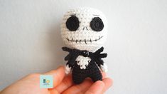 a small crocheted skeleton with a black bow tie