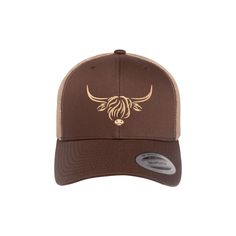 a brown and tan hat with an image of a bull's head on it