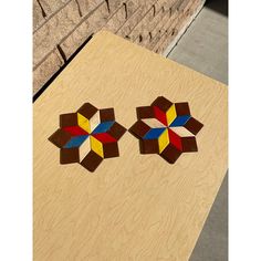 two pieces of wood that have been made to look like geometric designs on top of each other