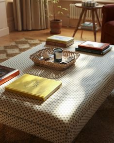 a coffee table with books and a basket on it