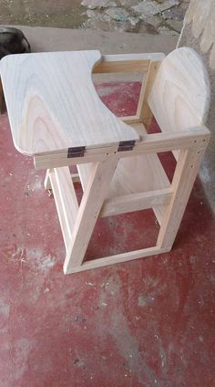 a wooden chair sitting on top of a red floor