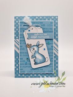 a blue and white card with a rabbit tag on it's side, in the shape of a bookmark