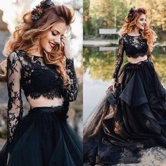 two piece black prom dress with long sleeves and flowers on the waist, in front of water