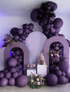 an image of a cake and balloons in the shape of the letter m on display