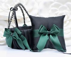 two black and green purses with bows on them