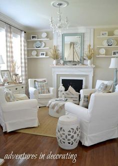 a living room filled with furniture and a fire place in front of a mirror on the wall