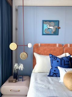 a bedroom with blue walls and white bedding