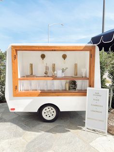 an ice cream truck with its doors open and shelves full of drinks on the outside